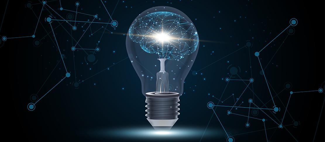 Light bulb illuminated against starry background